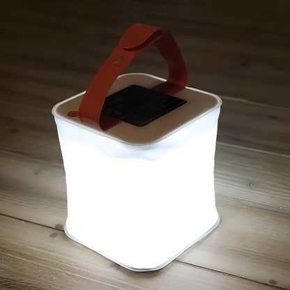 White inflatable solar LED lantern showing collapsed and inflated states with waterproof IP55 rating details