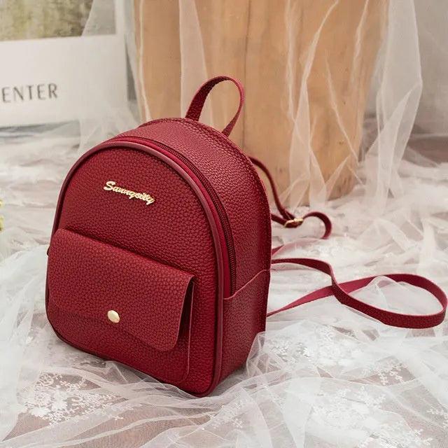 Small women's shoulder backpack in solid colour with zipper closure, dimensions 18.5cm x 8cm x 21cm