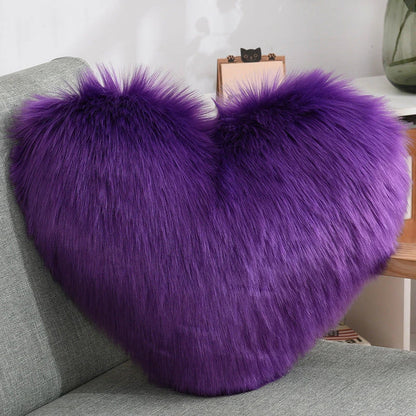 Cozy heart-shaped plush throw pillows in various colors and sizes for living room and bedroom decor