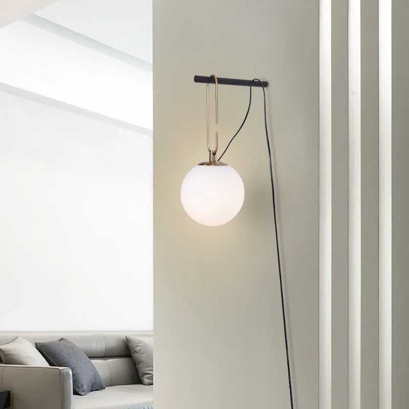 Modern glass wall lamp mounted on a wall, showcasing its clean design and adjustable light colour options.