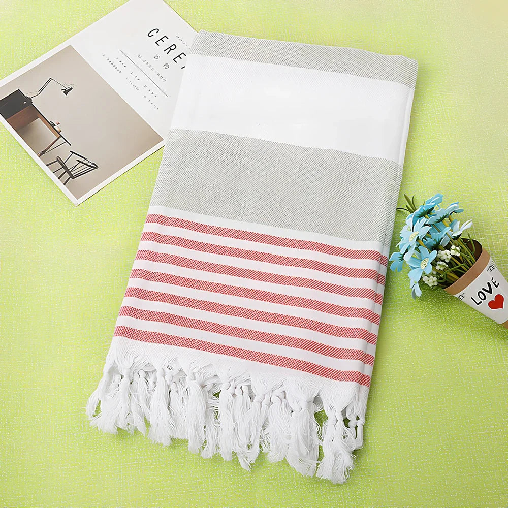 Striped Turkish beach towel showing blue and white pattern, measuring 100cm by 180cm