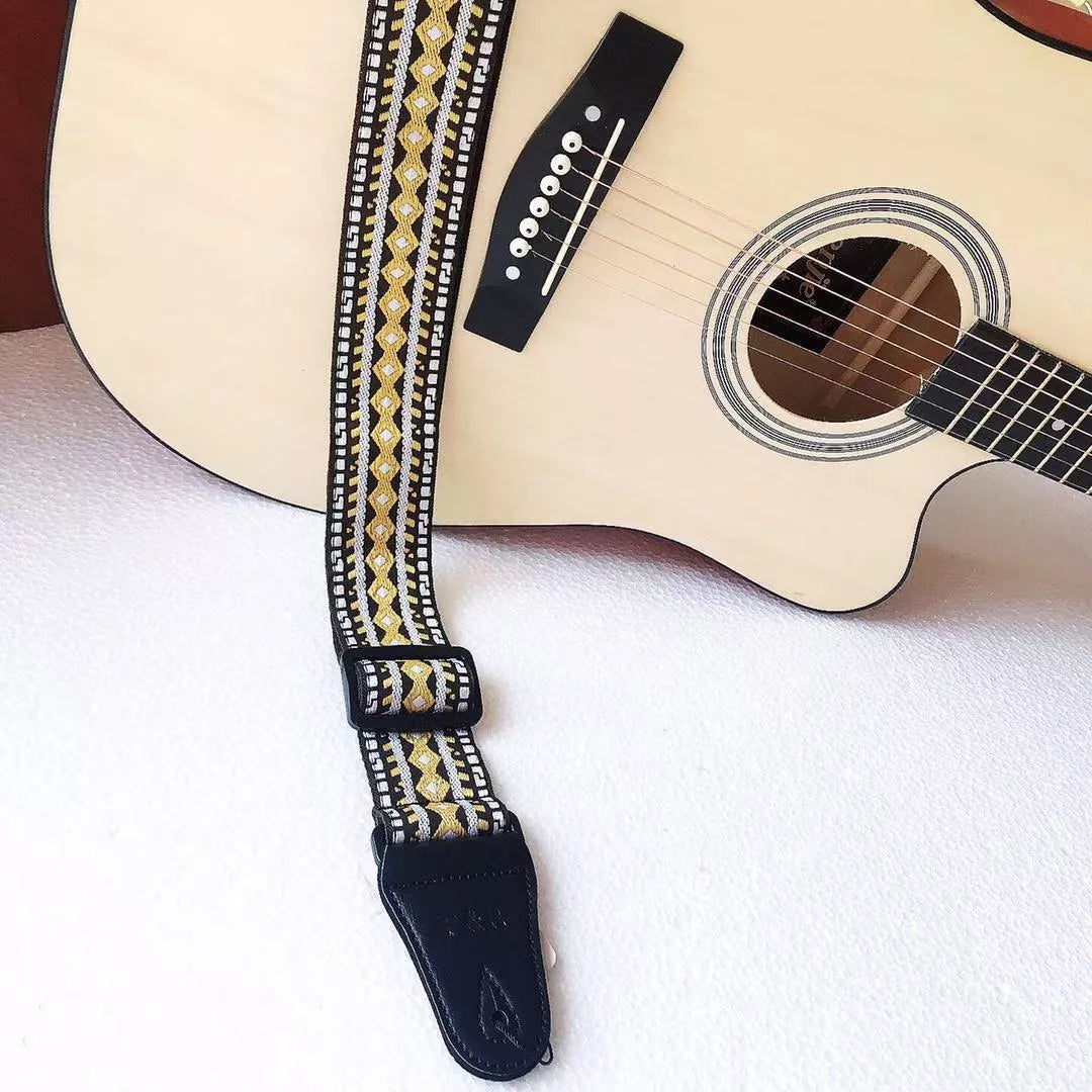 Adjustable embroidered guitar strap with durable webbing and intricate design
