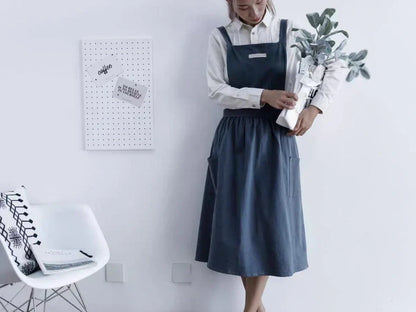 Sleeveless cotton kitchen apron in blue colour showing front coverage and adjustable neck strap