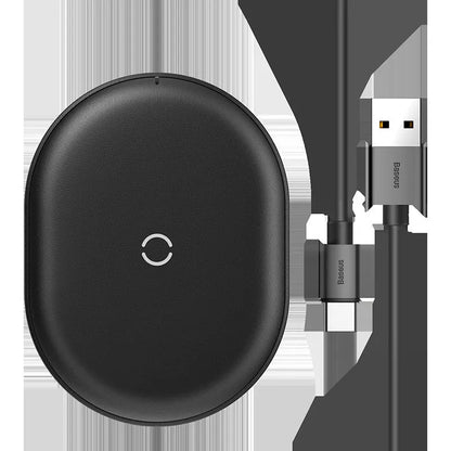 Baseus black 15W wireless charging pad with textured surface and Type-C cable on a wooden desk