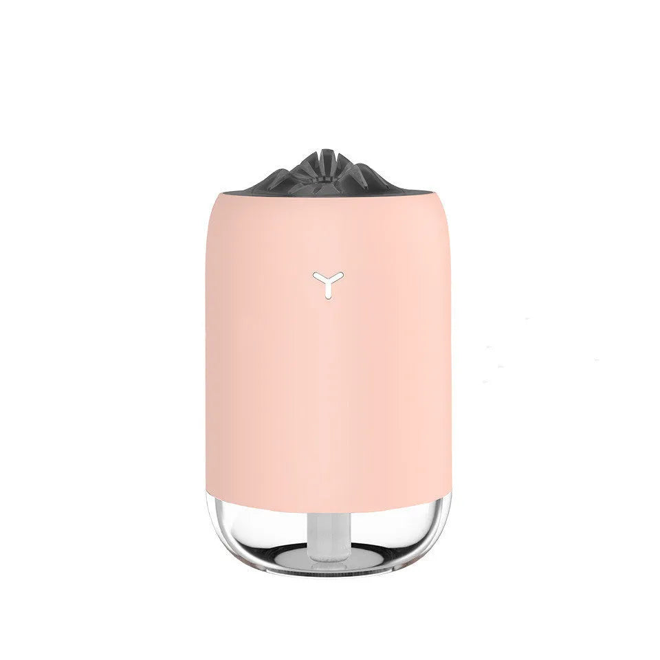 Compact cylindrical USB humidifier with night light in white, pink, or green, showing mist output.
