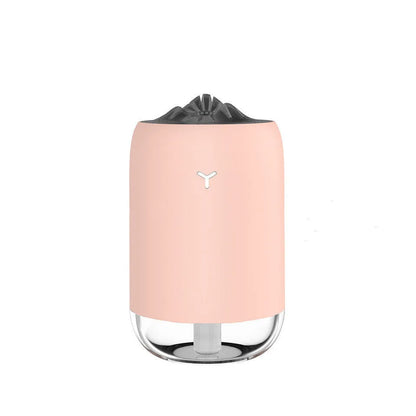Compact cylindrical USB humidifier with night light in white, pink, or green, showing mist output.
