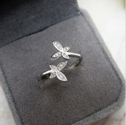 Adjustable sterling silver ring with intricate butterfly design, ideal for everyday wear or special occasions.