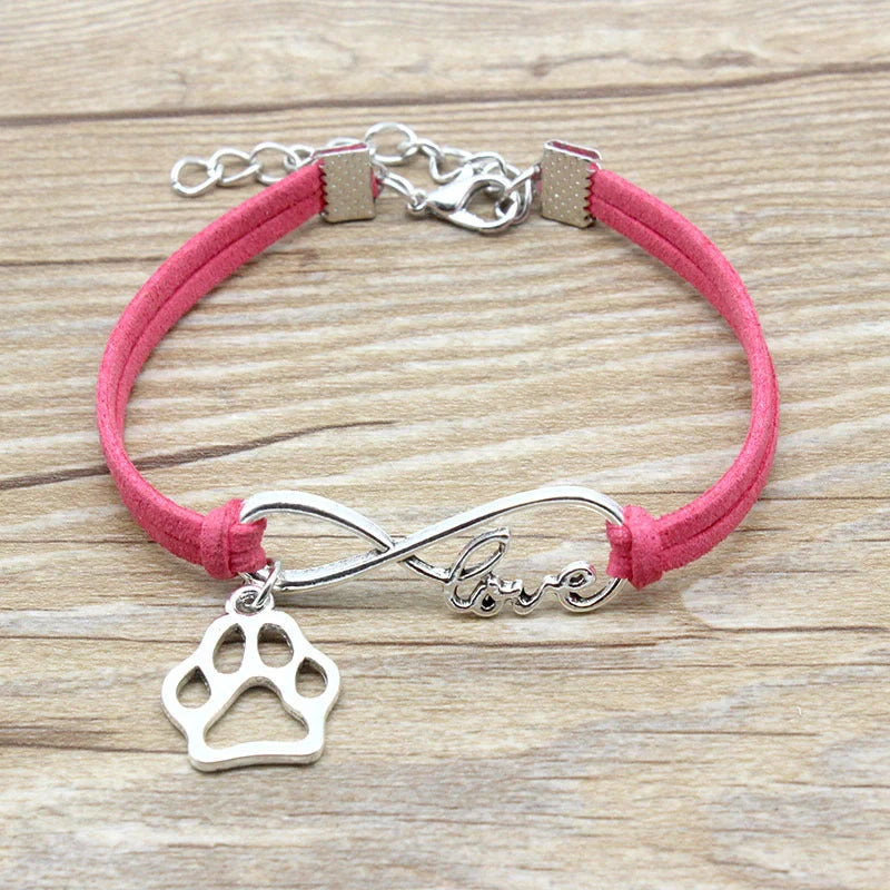 Hand-woven Infinite Love Pet Bracelet in various colors, showcasing the bow shape and alloy material.