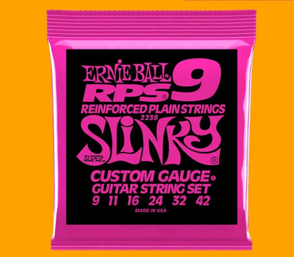 Coils of nickel-plated electric guitar strings and bass strings showing their metallic shine.