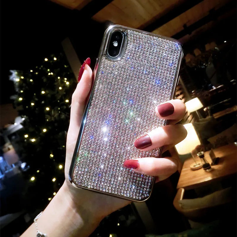 Silver silicone phone case with sparkling diamond decoration for various iPhone models.