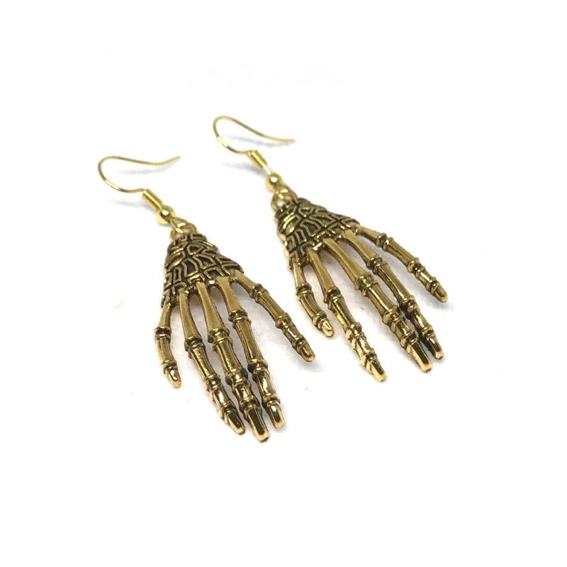 Vintage-inspired skull and skeleton earrings with intricate enamel details and a spooky-chic design