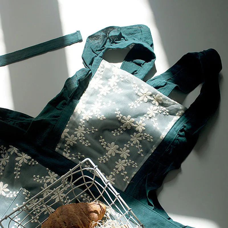 Minimalist kitchen apron with X-strap design in cotton linen fabric showing lace trim detail