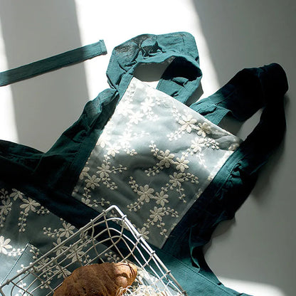 Minimalist kitchen apron with X-strap design in cotton linen fabric showing lace trim detail