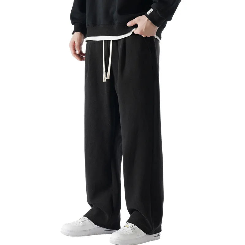 Men's double-sided polar fleece-lined trousers in apricot, black, or dark grey with elastic waist and loose fit for winter.