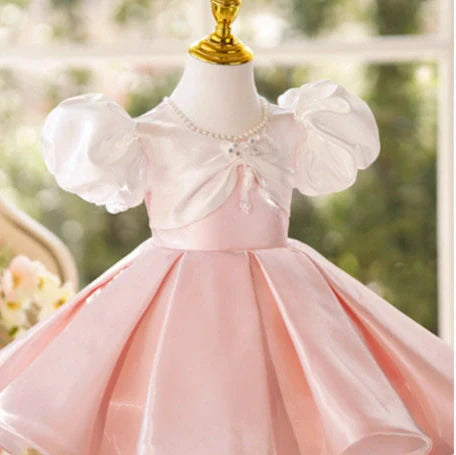 Girls pink puff sleeve princess dress with colour-coordinated design on hanger