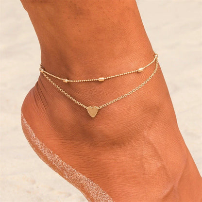 Trendy heart-shaped anklet with double-layered design and retro beach ball chain in gold, silver, and silvery colors.
