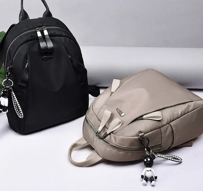 Medium square rucksack in Oxford cloth with two straps and a soft handle, shown in wine red.