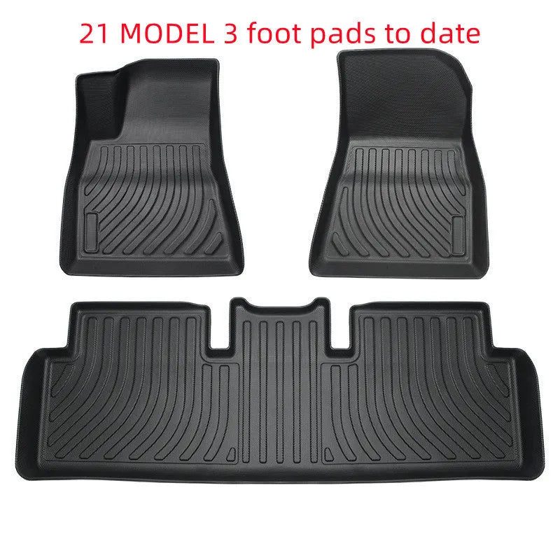 Black TPE rubber floor mats for Tesla Model 3, showing deep grooves and raised edges on driver's side.
