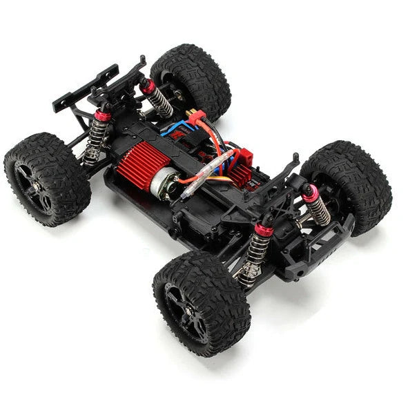 Blue REMO 1631 1:16 scale 4WD RC truck with transmitter on rough terrain