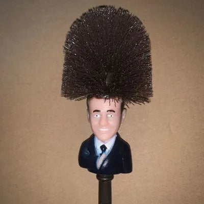 Yellow Donald Trump novelty toilet brush with hanging slot in handle