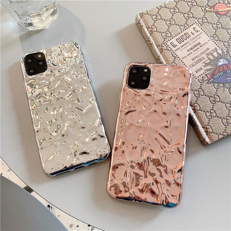 Rose gold electroplated TPU back cover case for iPhone on a table.