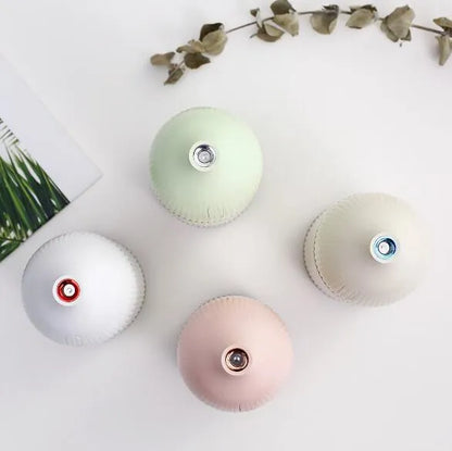 White USB-powered ultrasonic aromatherapy diffuser and humidifier with 300ml bottle and LED light on a desk.
