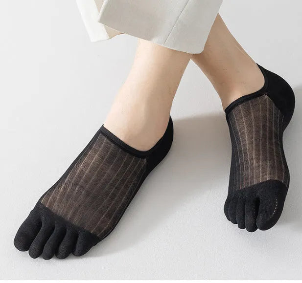 Pair of solid colour modal five-finger boat socks laid flat, showing individual toe compartments and low-cut design.