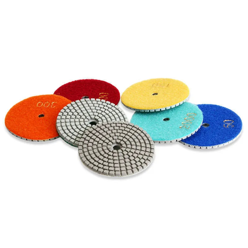 Set of 10 circular stone polishing pads with emery abrasive on a white background.