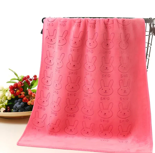 Beige microfiber bath towel demonstrating absorbency with water droplets on 600 GSM surface