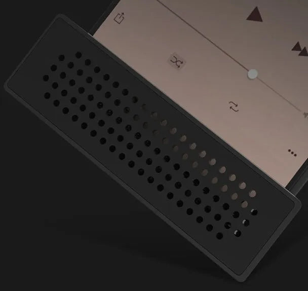 Portable black ABS plastic phone amplifier bracket holding a smartphone on a desk.