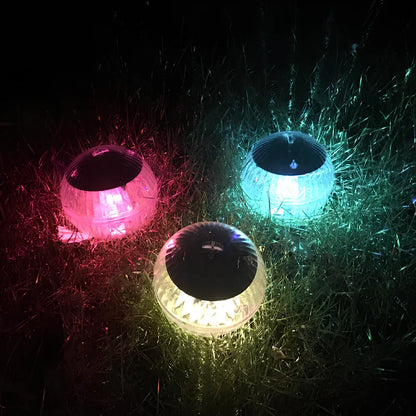 Solar-powered floating pool lights with colour-changing LEDs on water surface