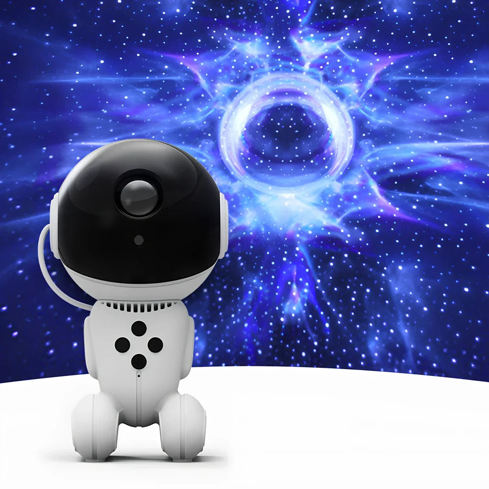 White robot-shaped star light projection lamp with USB cable and remote control on table