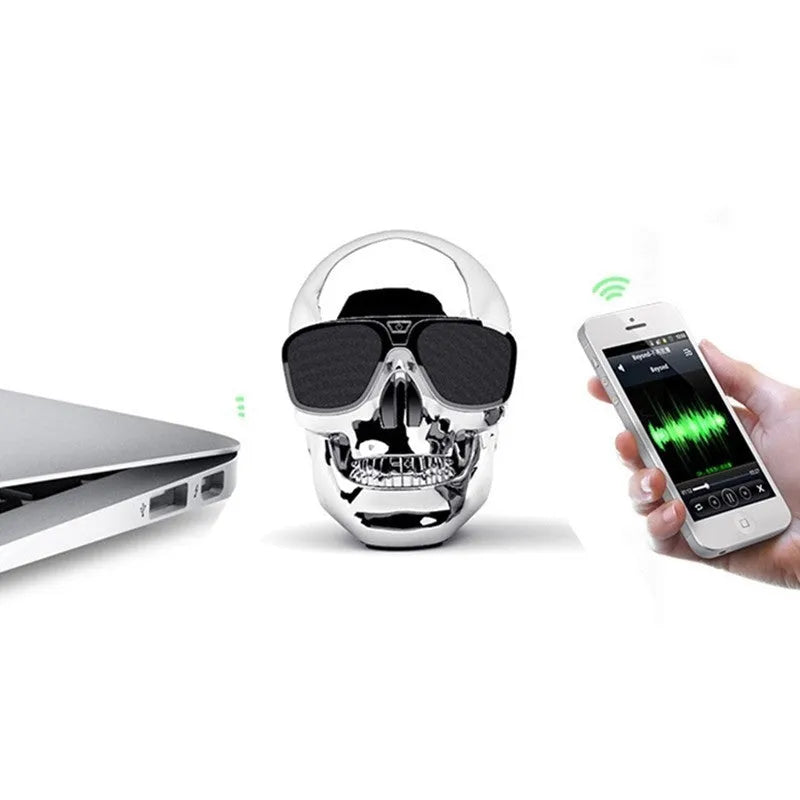 Limited edition Skull-shaped portable wireless Bluetooth speaker in various colours on a table.