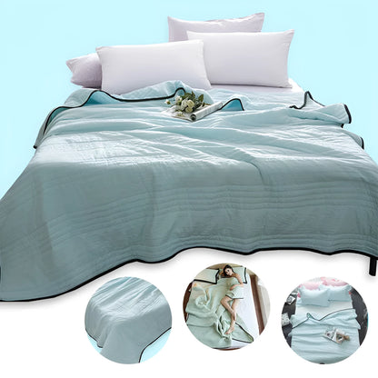 Lightweight plain coloured polyester summer quilt on a bed