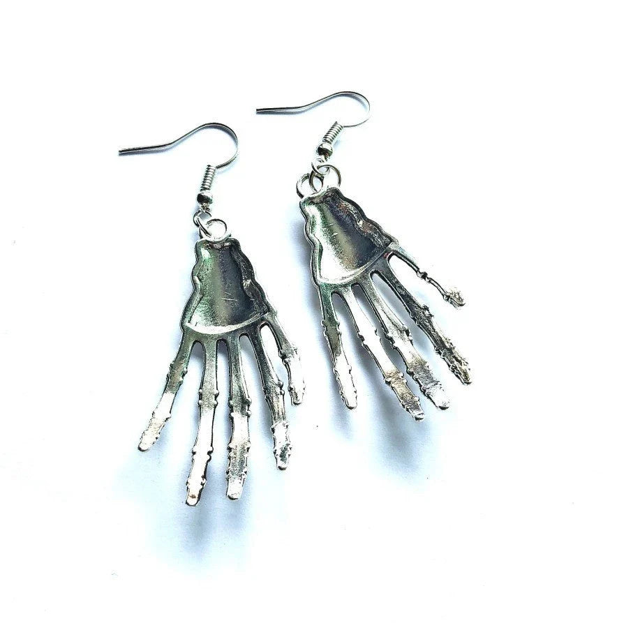 Vintage-inspired skull and skeleton earrings with intricate enamel details and a spooky-chic design