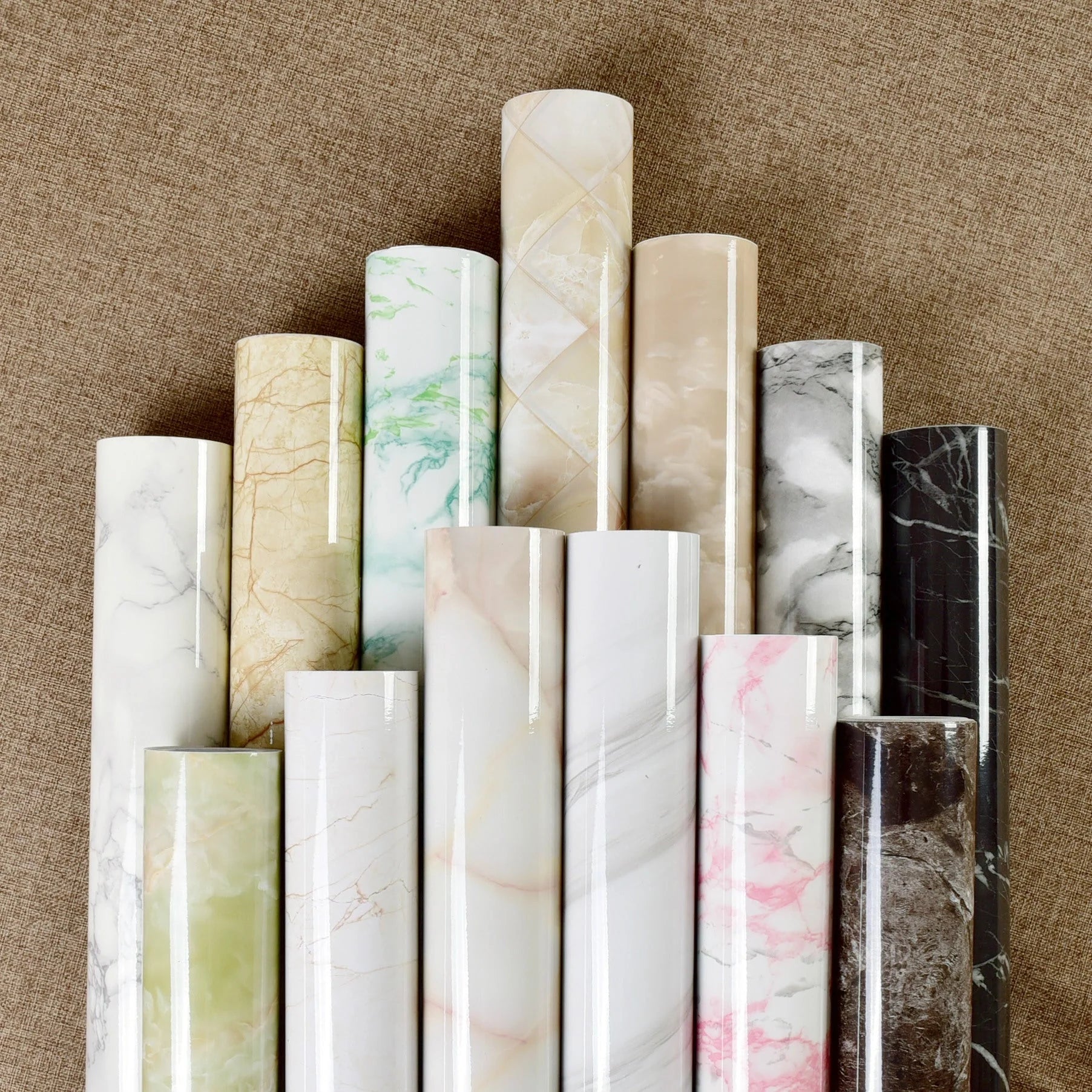 Premium peel-and-stick marble-look wall panels in various colors and sizes for kitchen and bathroom renovations