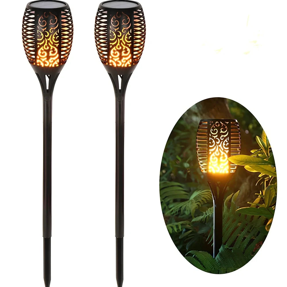 Solar garden LED light with flame flickering effect on stainless steel stake in outdoor setting