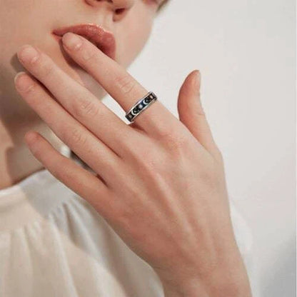 Stainless steel spinner ring with intricate moon and stars design