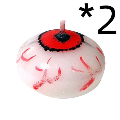 Red oval paraffin floating candle resembling eyeball in Halloween water display