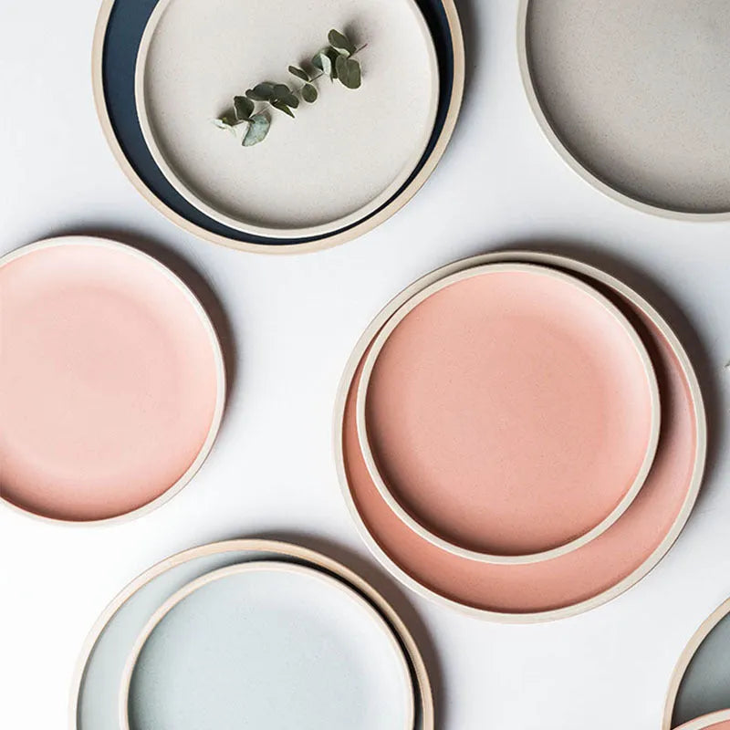 A blue matte-finish 10-inch ceramic dinner plate on a plain surface.