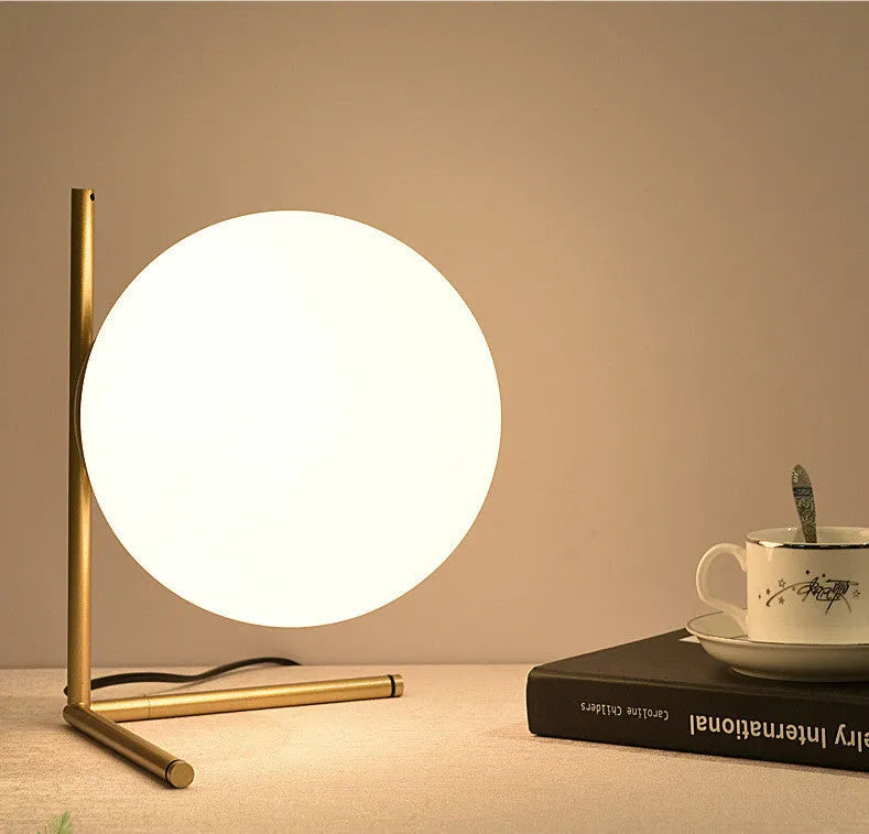 Creative glass table lamp with LED light in one of three available sizes for a living room or study