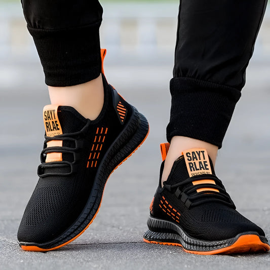 Men's black casual sports shoes with cross-strap detail on a Flying Weave upper and a flat, wear-resistant sole.