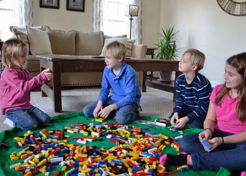 A large, waterproof travel picnic mat made of durable nylon with convenient toy storage bags for outdoor adventures.