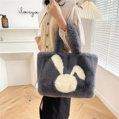 Cute cartoon rabbit ears design on a soft plush large capacity shoulder tote bag.