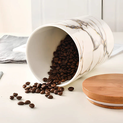 Three marbled ceramic storage jars with wooden lids showing large, medium, and small sizes