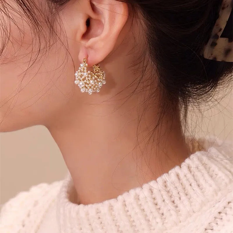 Gold-colour copper flower basket earrings with small rice-shaped bead inlay detail.
