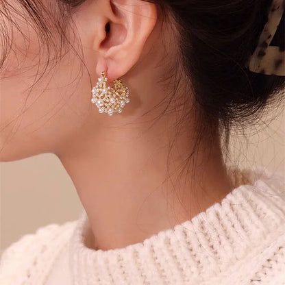 Gold-colour copper flower basket earrings with small rice-shaped bead inlay detail.