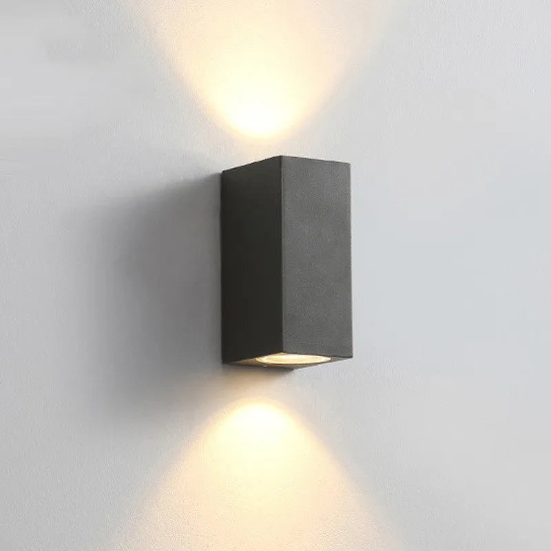 Black LED wall lamp with aluminium body and glass shade mounted on wall