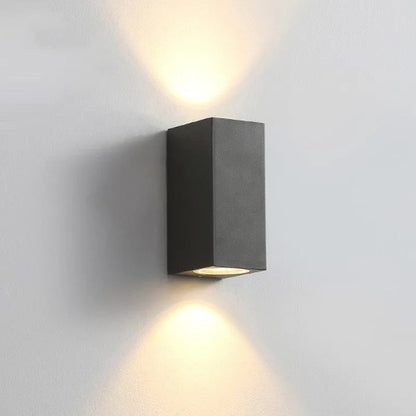 Black LED wall lamp with aluminium body and glass shade mounted on wall