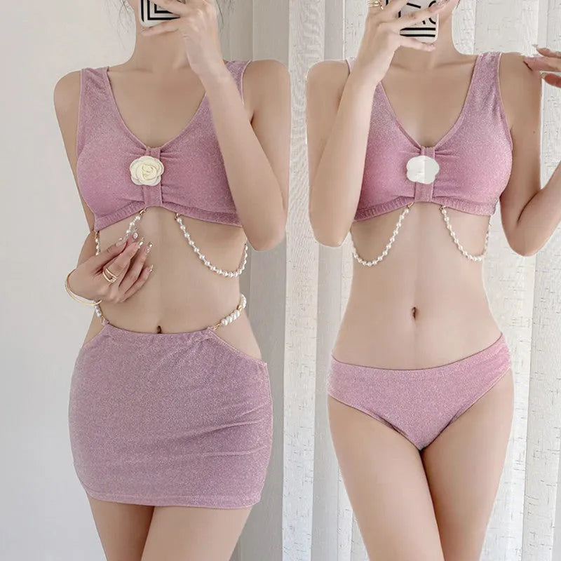 Pink and black three-piece bikini set with briefs style and sleeveless design for swimming.